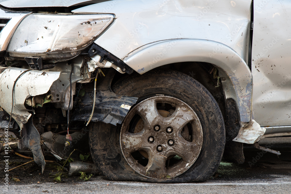 .Front tire and wrecked cars. .Front tire and wrecked cars.