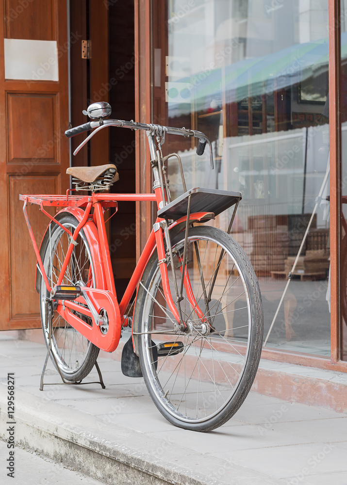 Red bicycle standing on street