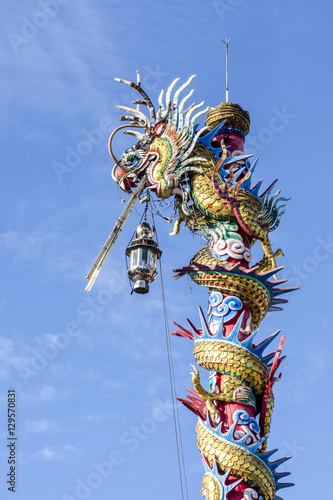 The Chinese dragon statue with blue sky background.