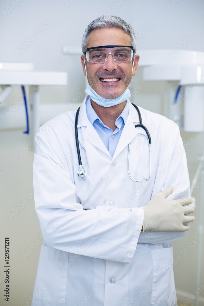 Portrait of smiling dentist standing with arms crossed Portrait of smiling dentist standing with arms crossed