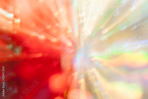 Blurred red and white background with radiating from the center rays © aleoks