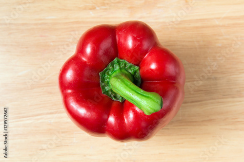 red sweet pepper on a wooden block