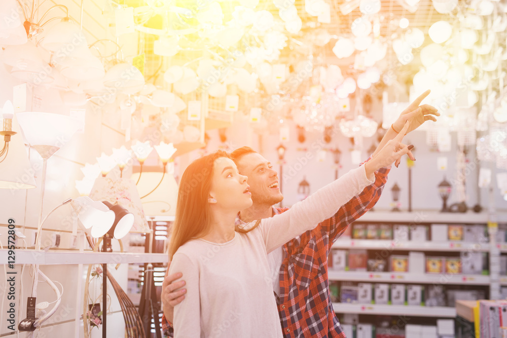 young couple shopping for DIY tools at hardware store.cheerful young couple shopping in hardware store young couple shopping for DIY tools at hardware store.cheerful young couple shopping in hardware store