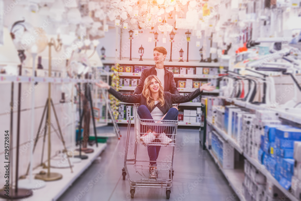 young couple shopping for DIY tools at hardware store.cheerful young couple shopping in hardware store young couple shopping for DIY tools at hardware store.cheerful young couple shopping in hardware store