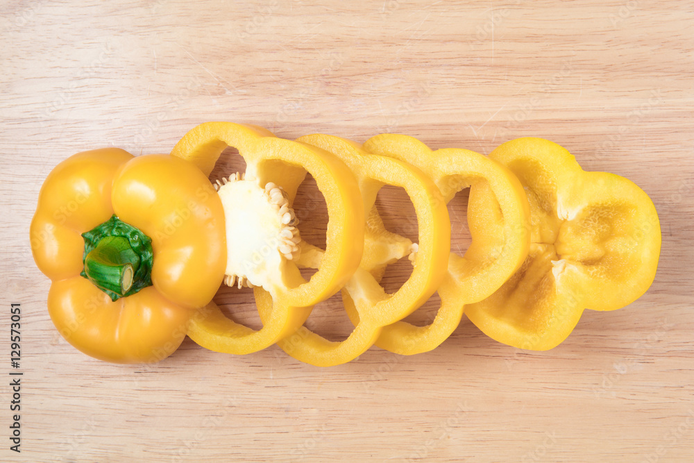 sliced yellow sweet pepper on a wooden block sliced yellow sweet pepper on a wooden block