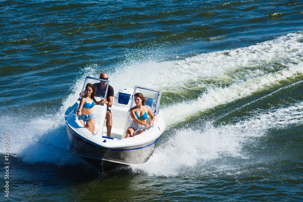 Fototapeta premium Girls ride on the boat to drift