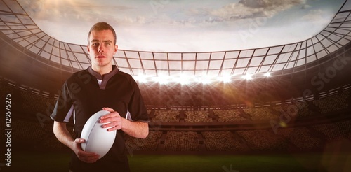 Composite image of rugby player holding a rugby ball 