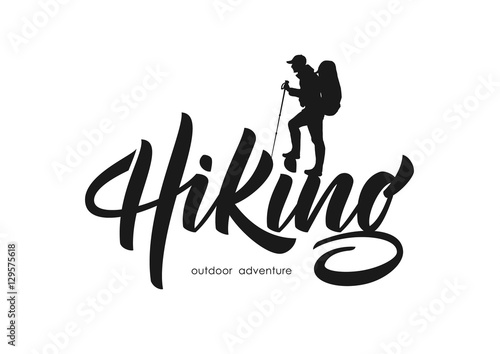 Vector illustration: Modern brush lettering of Hiking with silhouette of climber. photo