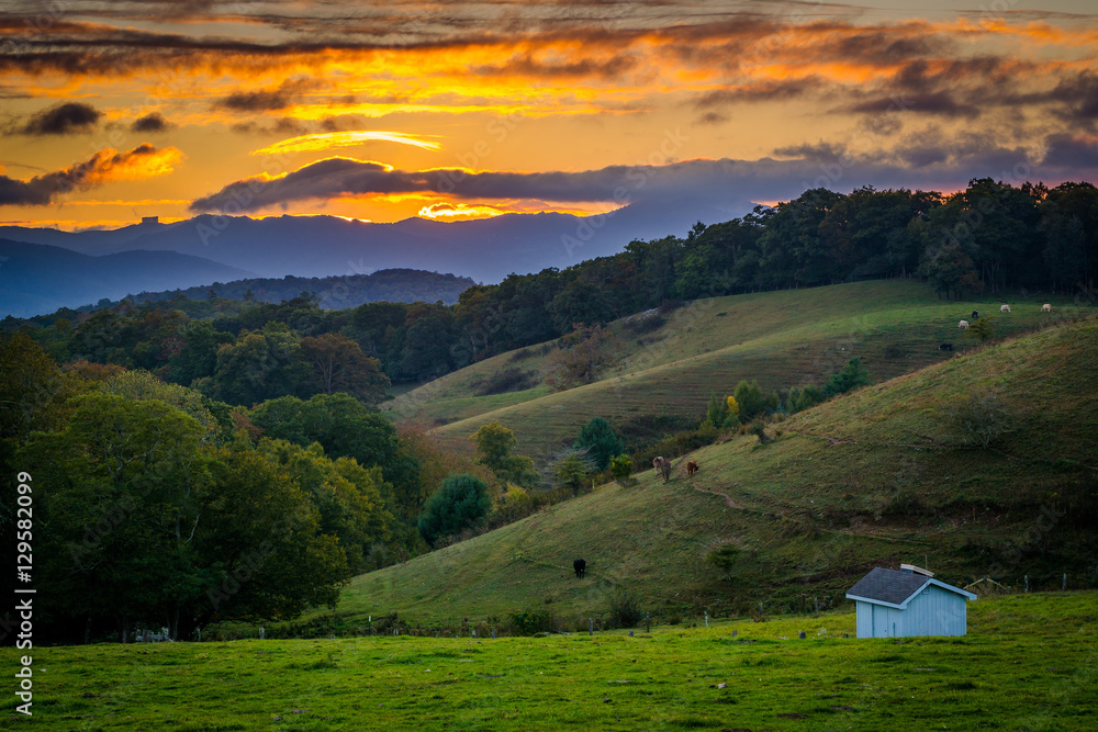 Sunset over rolling hills and farm fields at Moses Cone Park on
