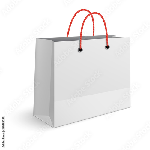 Classic paper shopping bag with red rope handles isolated