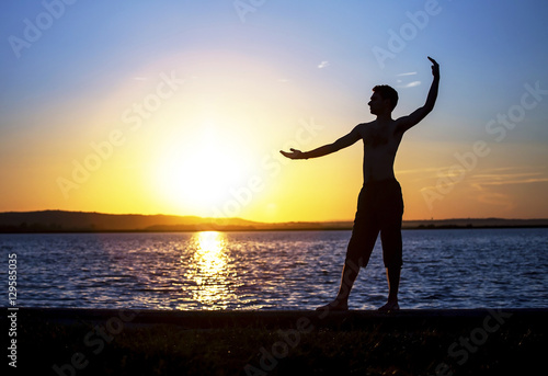 Enjoying life - young man standing on the beach