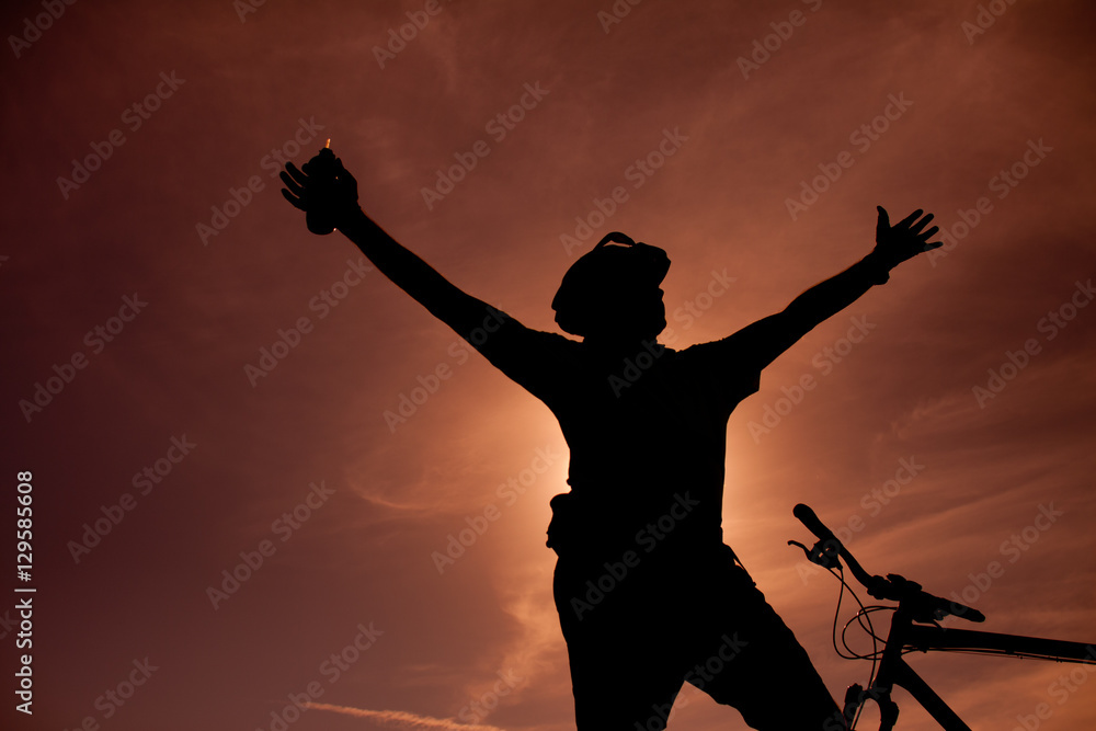 Silhouette of a man with a bike Silhouette of a man with a bike