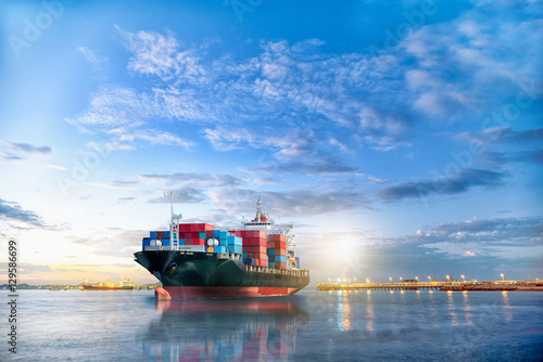 Logistics and transportation of International Container Cargo ship in the ocean at twilight sky, Freight Transportation, Shipping © enanuchit