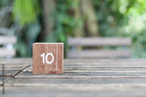 Wooden Cube. Block of wooden with numbers ten on natural background.