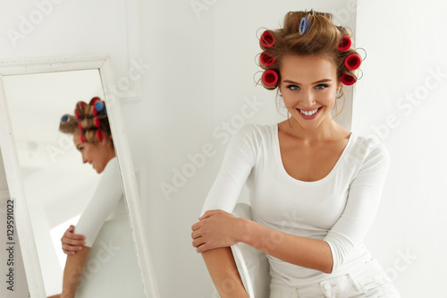Woman Getting Ready. Beautiful Model With Hair Rollers On Hair