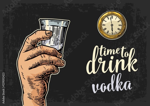 Male hand holding glass vodka and antique pocket watch