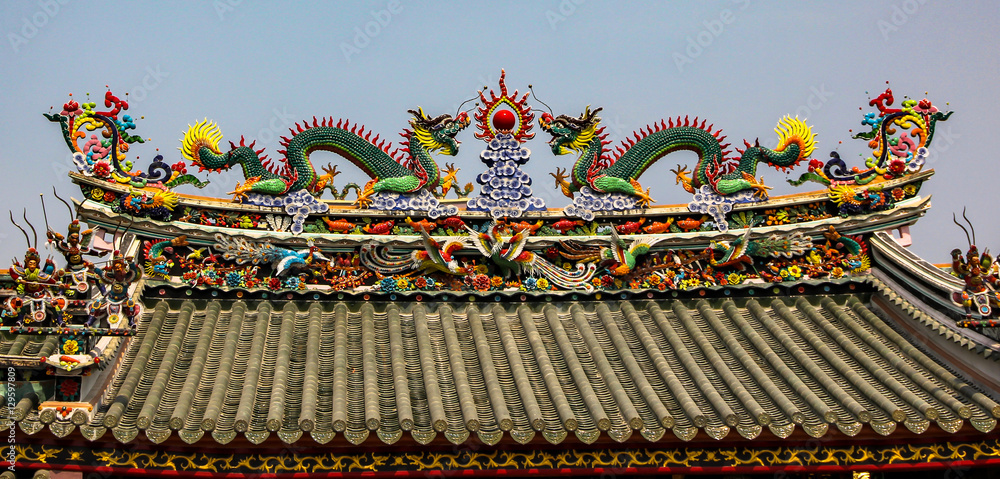 Coloured roof of a hindu temple with dragons Coloured roof of a hindu temple with dragons