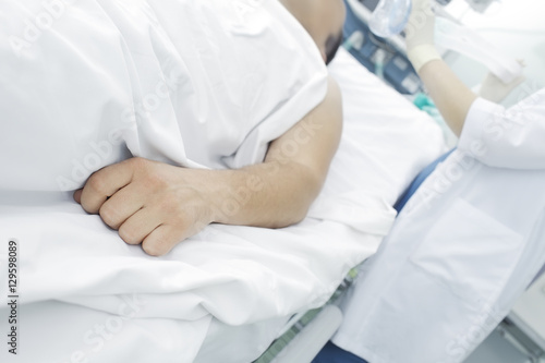 Nurse working with patient in ICU
