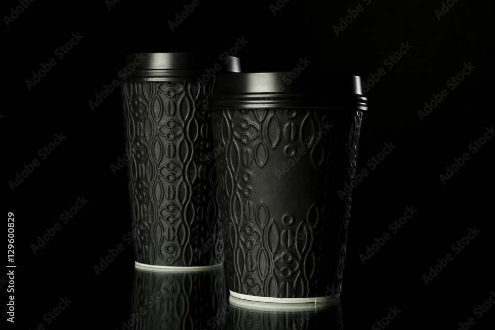 Black paper coffee cups on black background Black paper coffee cups on black background