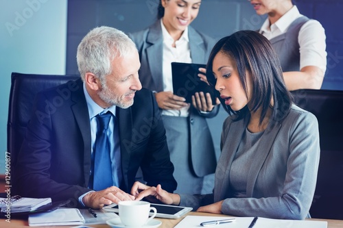 Businessman and businesswoman using digital tablet