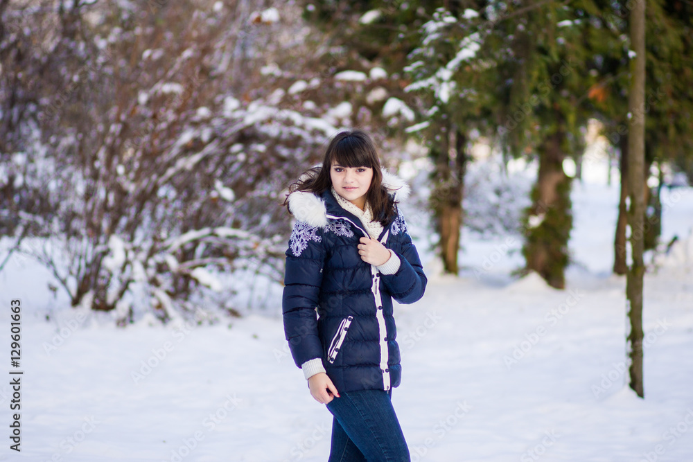 Pretty girl standing in a winter park Pretty girl standing in a winter park