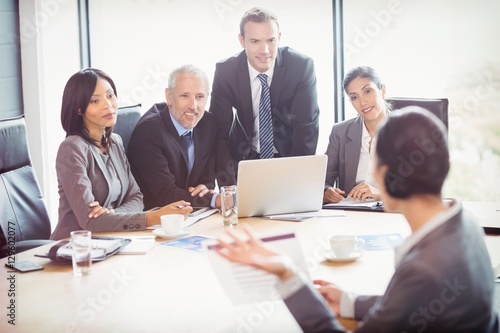 Businesspeople interacting in conference room