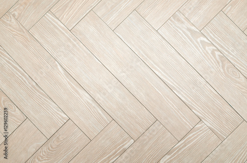 Beige floor tiles with look of parquet as a background
