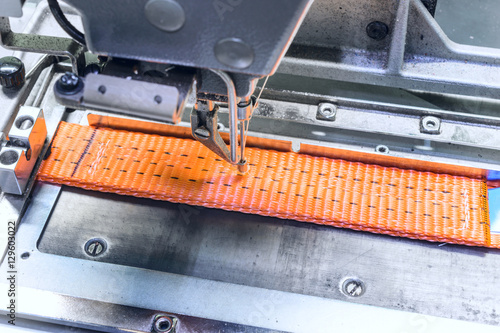 Принти на полотні Industrial sewing machine sews a ratchet strap.