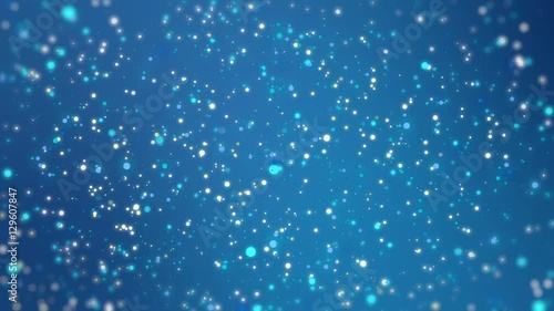 Magical glitter depth of field background with glowing colorful light particles flickering against blue backdrop and blurred edges.