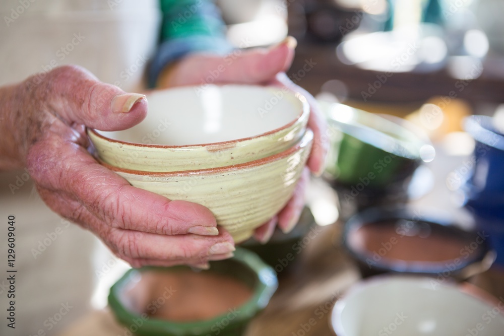 © WavebreakMediaMicro - Close-up of female potter holding bowl