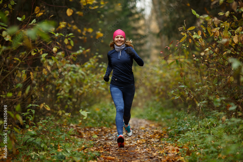 Portrait in full growth of running young women in forest Portrait in full growth of running young women in forest