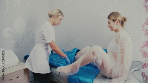 Hardware figure correction. Machine cosmetology. Woman on pressure therapy procedure. Anti-cellulite program for health and slimming. Woman in a special suit preparing for pressure therapy procedure. photo