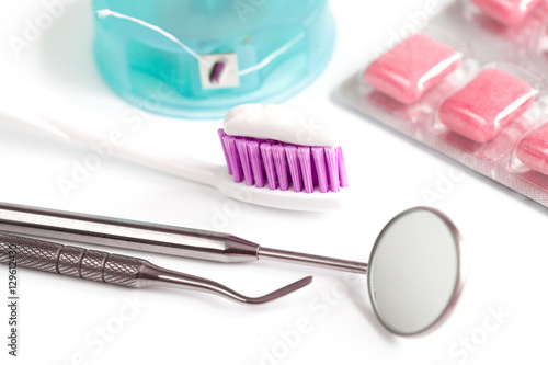 dental care toothbrush with dentist tools on white background