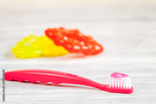 children s toothbrush oral care on wooden background