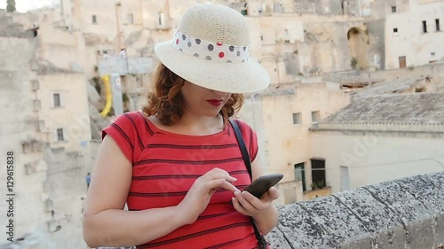 woman using smart phone: girl typing messages whit mobile touchscreen phonen photo