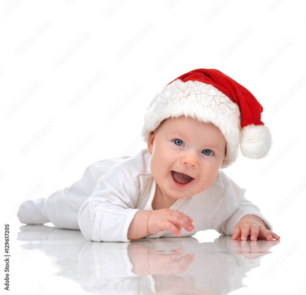 Infant child baby girl lying in red christmas santa hat happy sm Infant child baby girl lying in red christmas santa hat happy sm