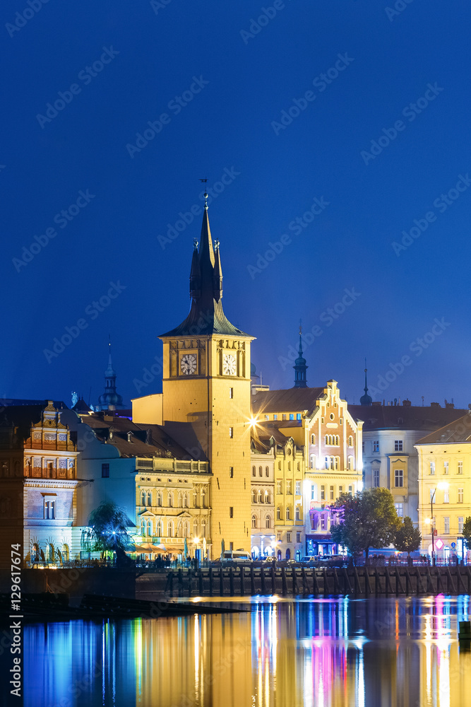 Obraz premium Old Water Tower At Night, Reflection In River. Prague, Czech Republic