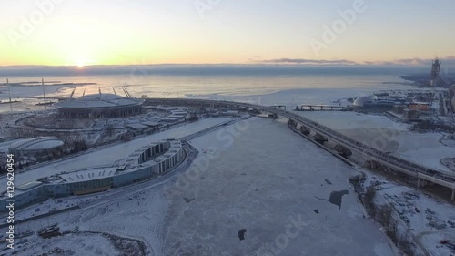 Aerial view of The third cable-stayed bridge, the bridge through a ship waterway, near the football Zenith Arena stadium dated for the FIFA World Cup in 2018, the snow, the frozen river Neva photo