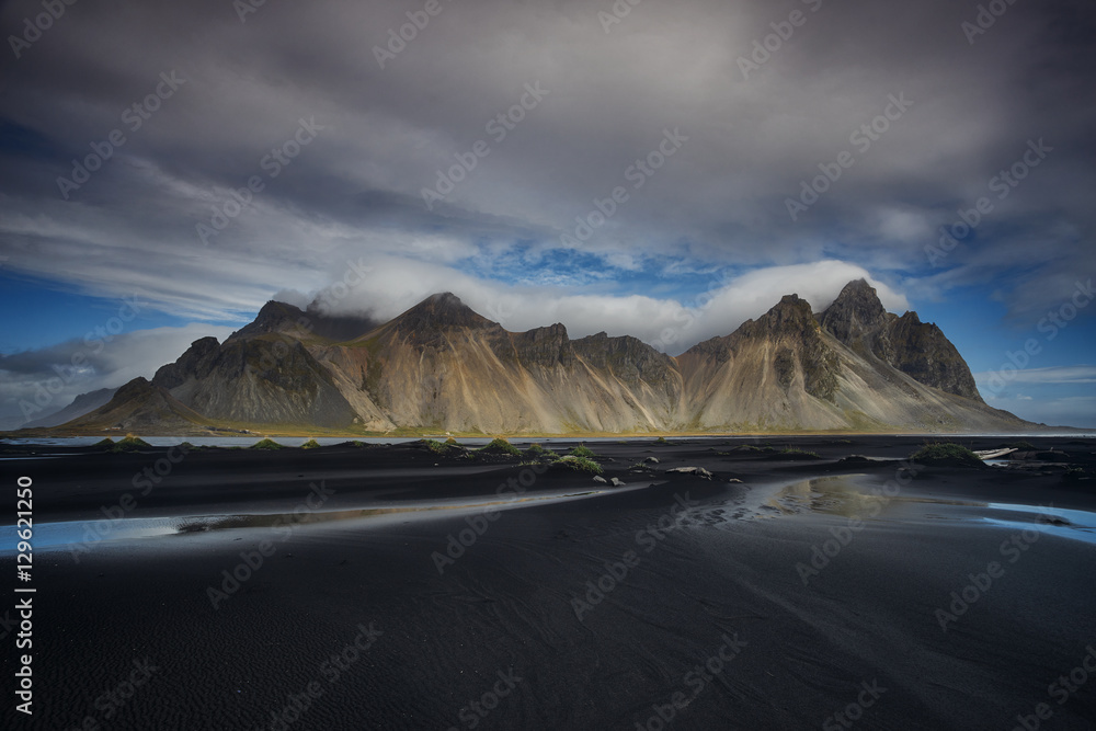 Vesturhorn Mountain and black sand dunes in rain clouds, Iceland
