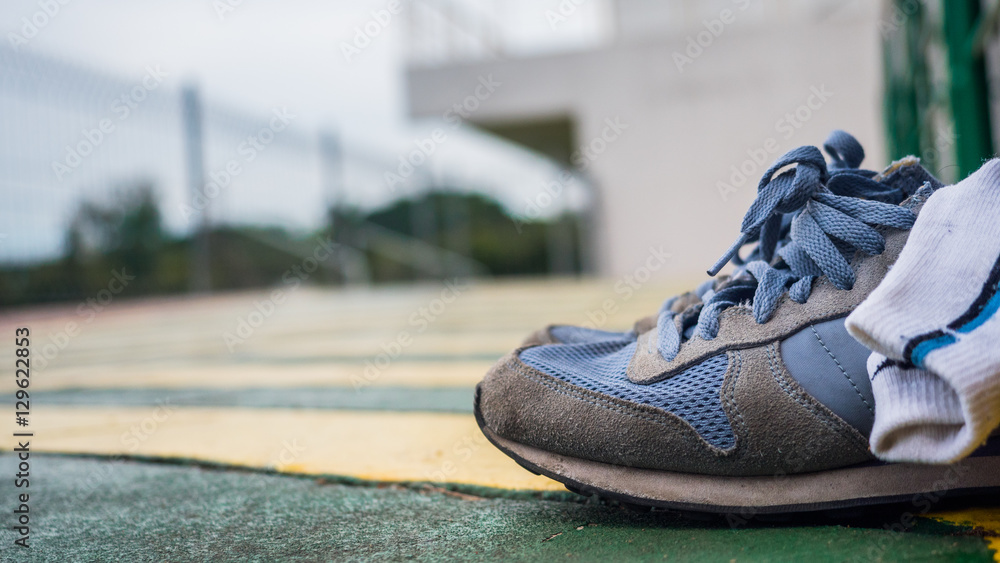 Running shoes on walkway.