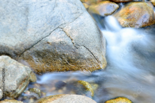 Selective focus of water flowing over rocks in dry evergreen forest,thailand.