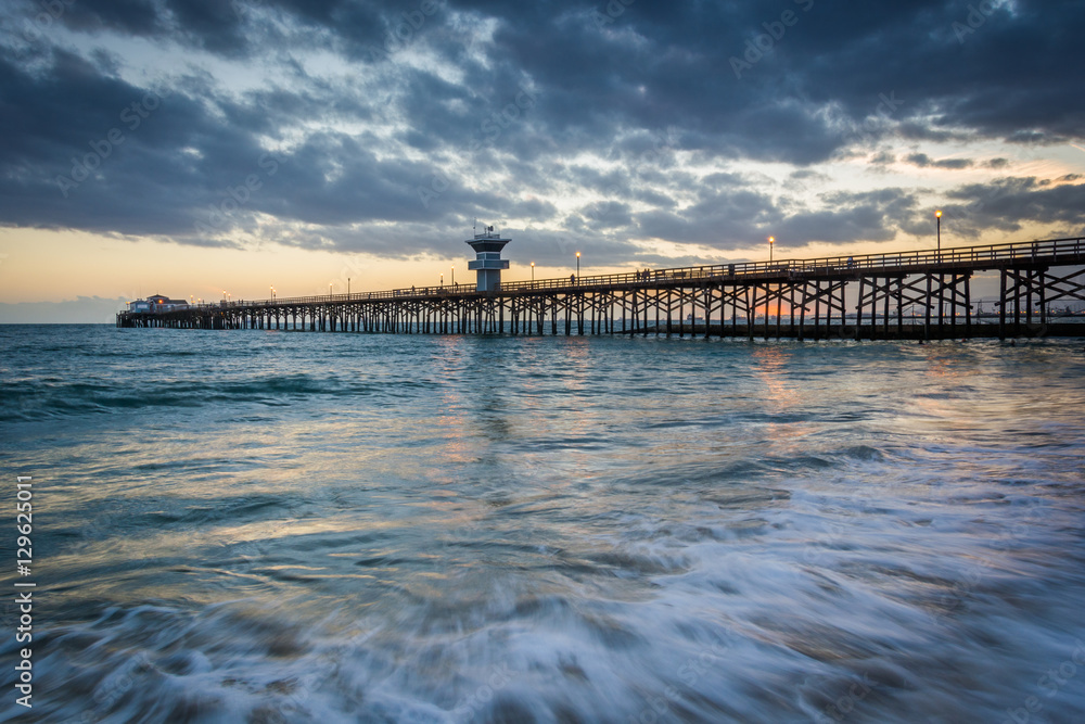 Waves in the Pacific Ocean and the pier at sunset, in Seal Beach