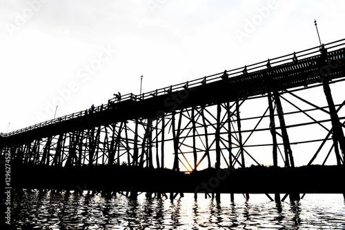 silhouette wooden bridge across river at sangkhalaburi thailand