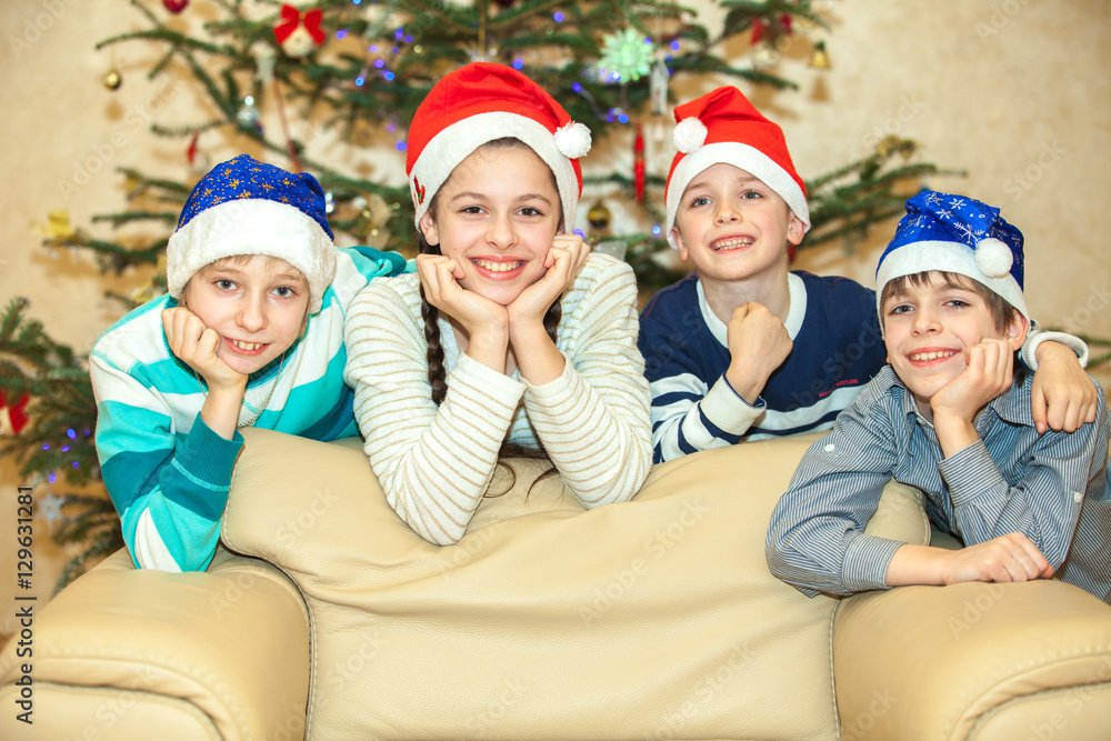 Happy group of children near a Christmas tree Happy group of children near a Christmas tree