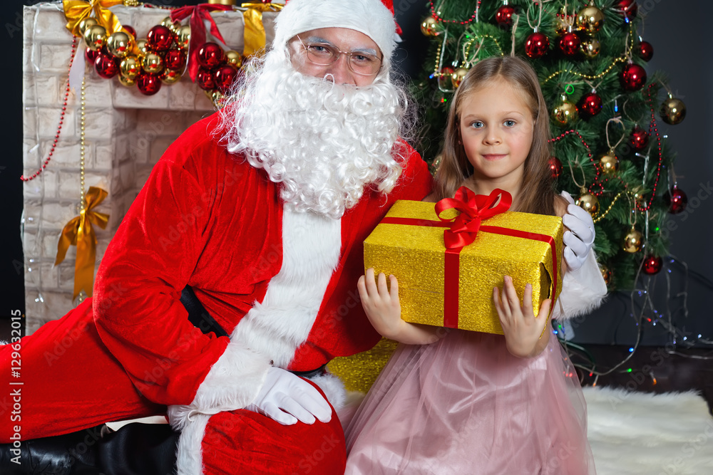 Santa Claus and a girl in a dress. Christmas Scenes.