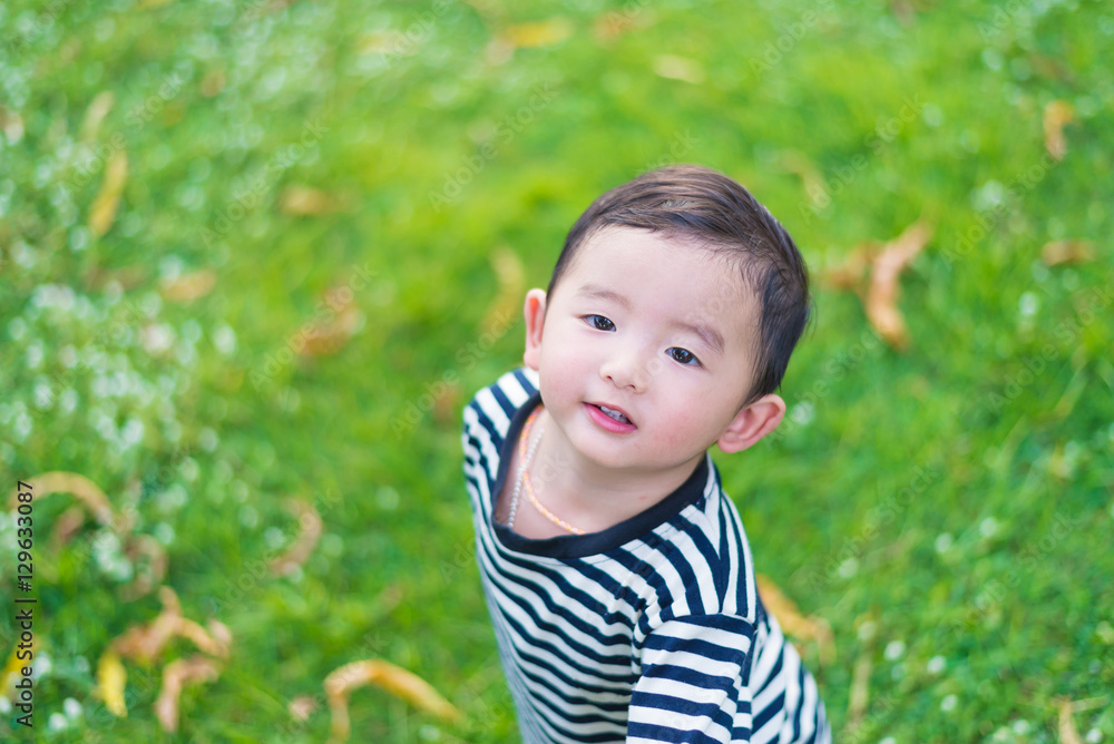 Close-up little Asian boy looking up somewhere and thinking with Close-up little Asian boy looking up somewhere and thinking with