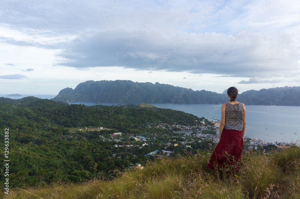 Tourist overlooking Coron town and Coron island from Mt Tapyas, Palawan, Philippines