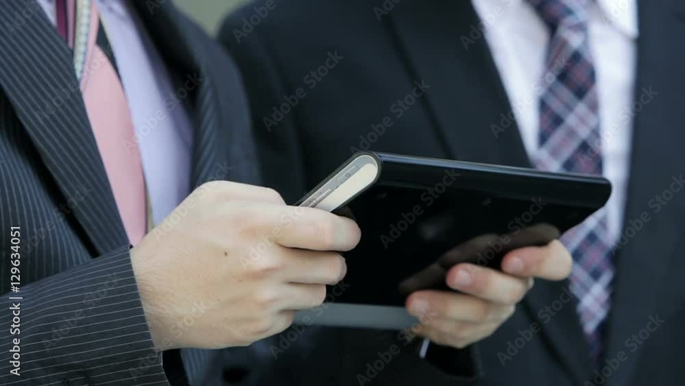 businessmen working outdoor with tablet computer businessmen working outdoor with tablet computer