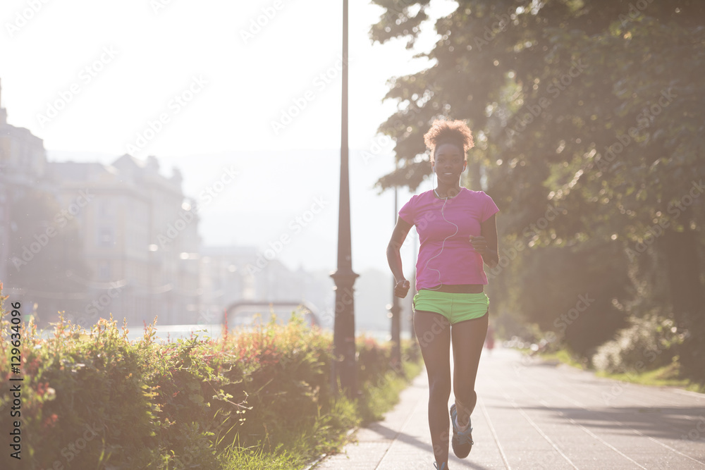 Fototapeta premium african american woman jogging in the city