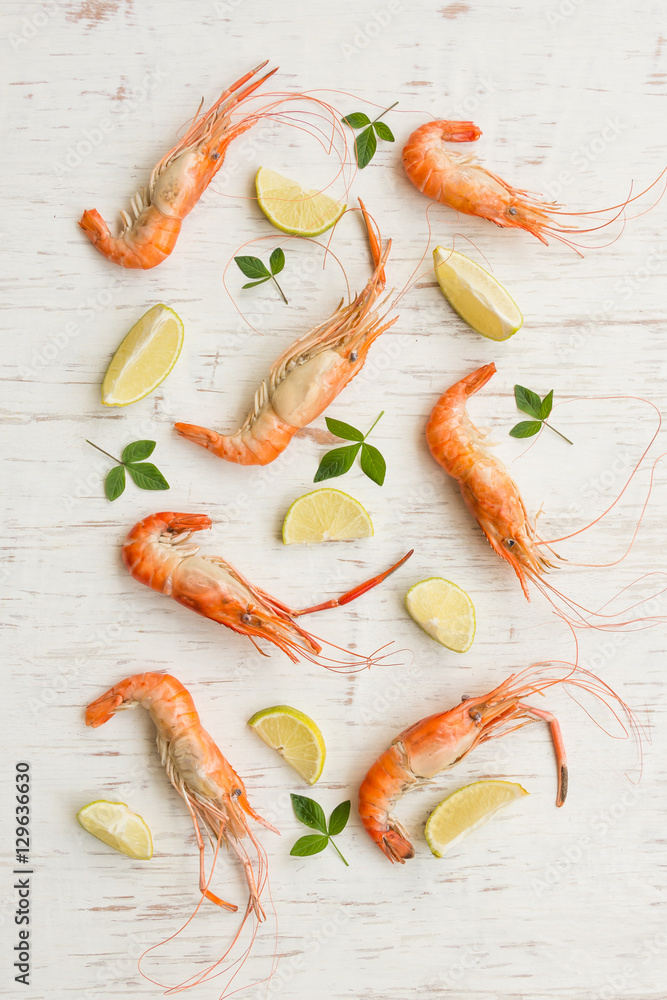 River shrimp and lemon on white rustic wooden background River shrimp and lemon on white rustic wooden background